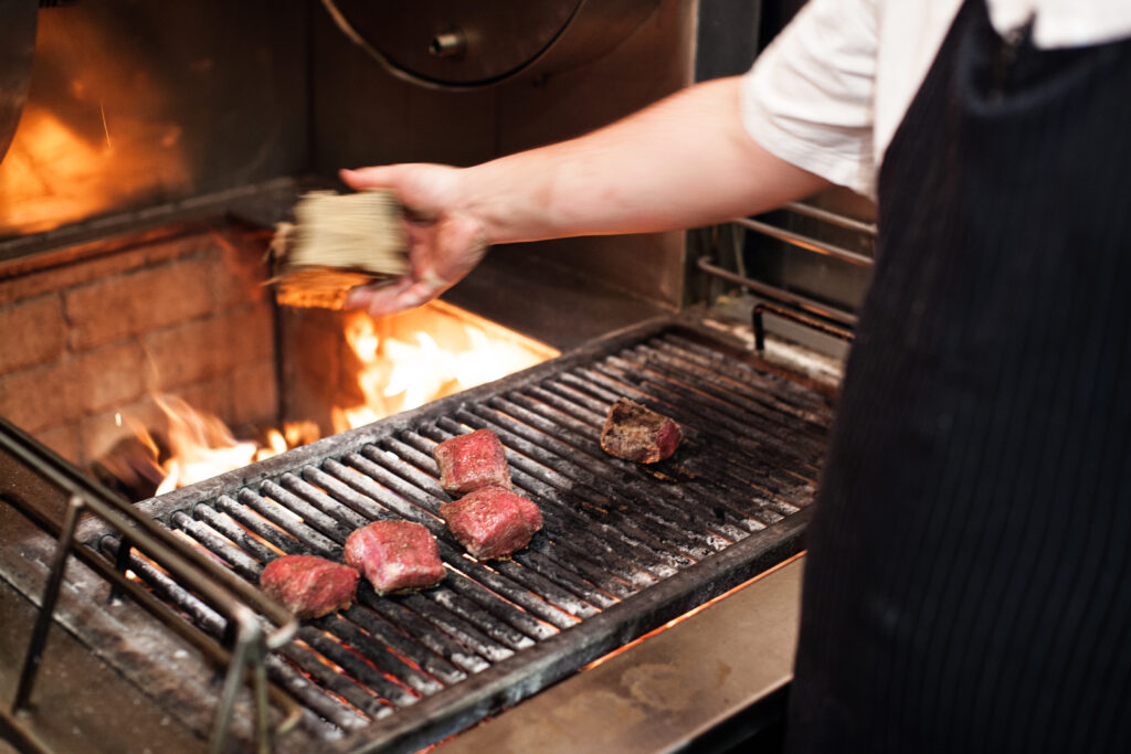 Engage your guests at the Chef’s Table, watching our chefs at our live wood-fired grill.